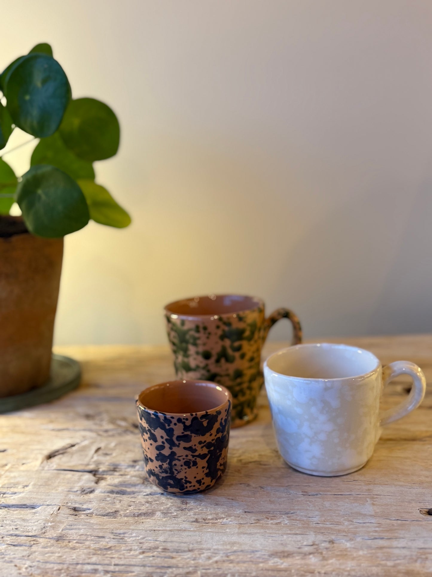 Pale stone & white splatterware cup