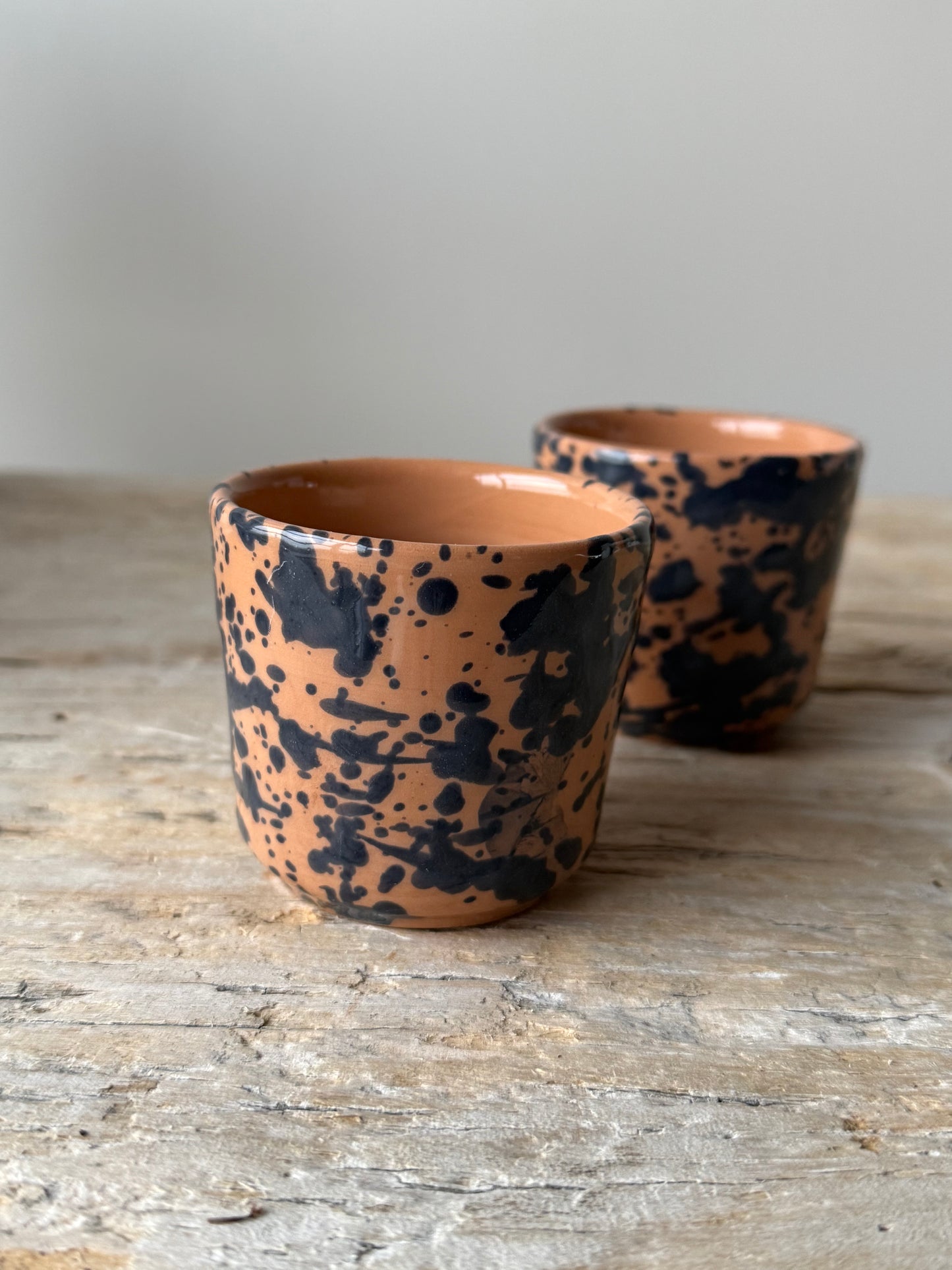 Pale terracotta & navy splatterware beaker