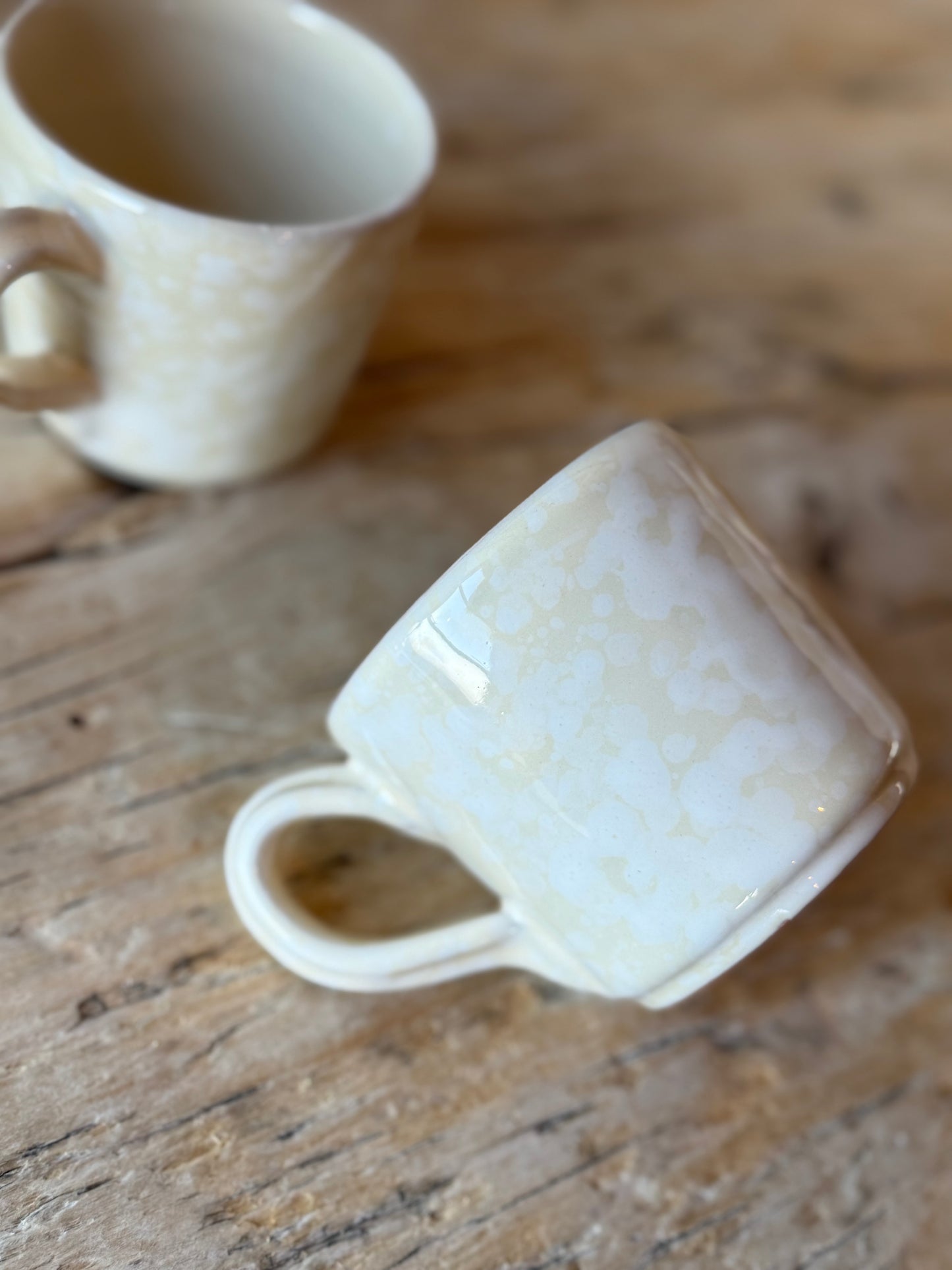 Pale stone & white splatterware cup