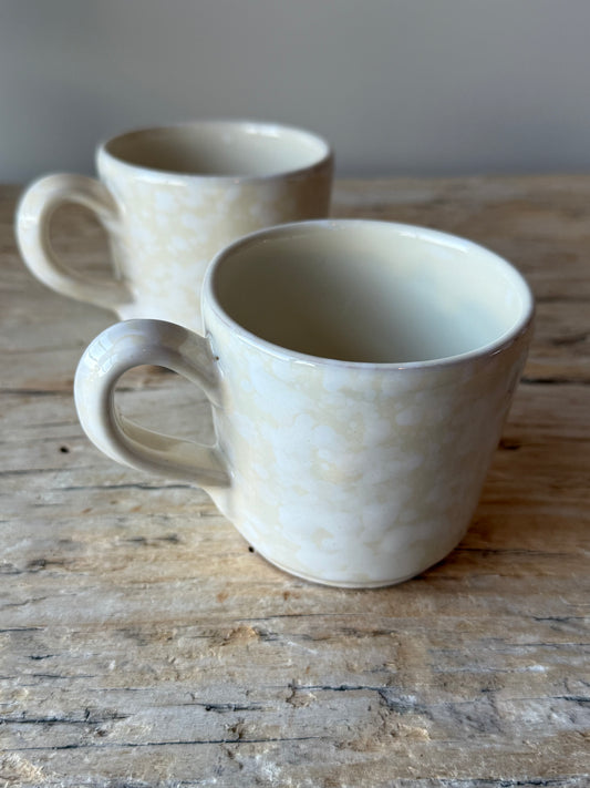 Pale stone & white splatterware cup